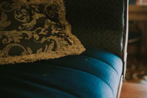 a blue couch with a black and gold pillow at Royal Valentia Hotel in Valentia Island