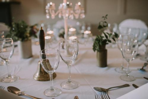 a table with wine glasses on a white table cloth at Royal Valentia Hotel in Valentia Island