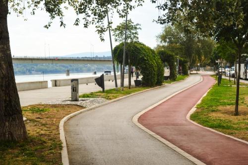 a winding road in a park next to the water at Apartment Riverside Gem in Novi Sad