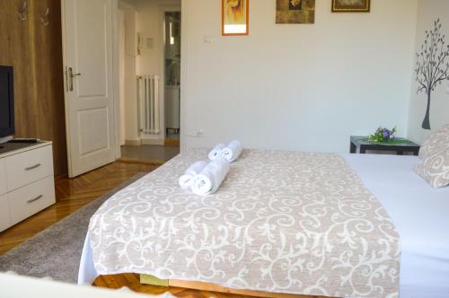 a bedroom with a bed with two towels on it at Apartment Riverside Gem in Novi Sad