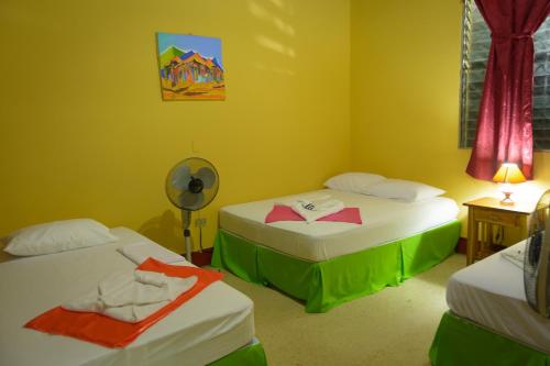 a room with two beds and a fan in it at Hostal Fachente in León