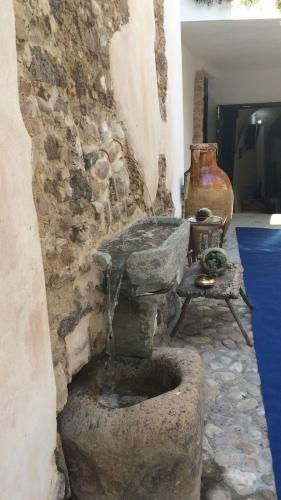 a stone wall with a water fountain in a room at Residenza La Nivera in Miglionico