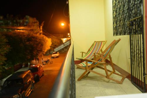 a couple of chairs sitting on a balcony at Hostal Fachente in León