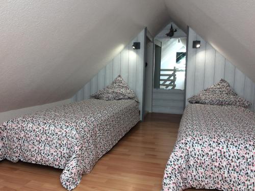 a bedroom with two beds and a window at Katy's Home Dinard in Dinard