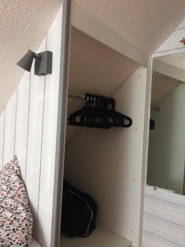 a room with a closet with a bed and a door with at Katy's Home Dinard in Dinard