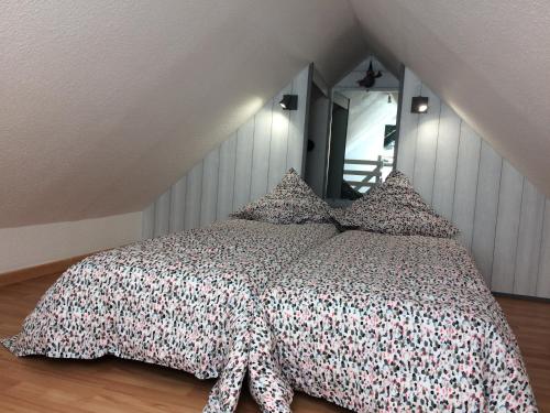 a bedroom with a bed with a comforter on it at Katy's Home Dinard in Dinard