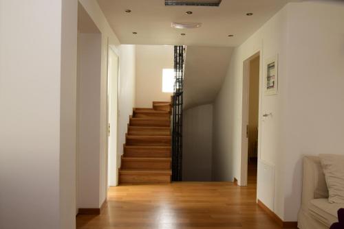 a hallway with a staircase in a house at La Belle Helene in Kymi