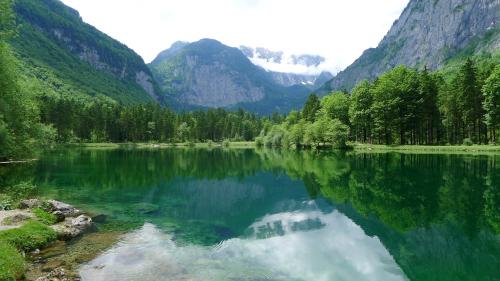 a lake in the middle of a valley with mountains at Alpenhaus Dachstein.Zauber in Abtenau