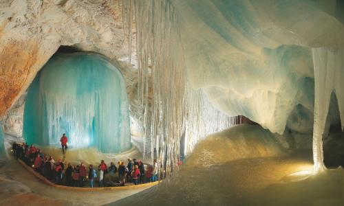 a group of people standing inside of an ice cave at Alpenhaus Dachstein.Zauber in Abtenau