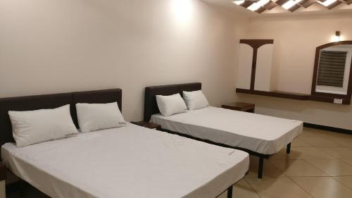 מיטה או מיטות בחדר ב-Ashok Bhavan