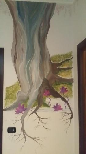 a painting of a tree on a wall at Guest House Park in Valmontone
