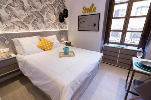 a bedroom with a bed with a tray on it at BeSalamanca in Salamanca