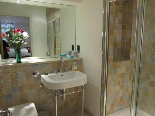 a bathroom with a sink and a shower at Bridge Street Apartments in Inverness