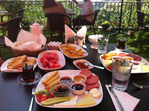 a table with many plates of food on it at Sapanca Dilek Konagi Hotel in Sapanca