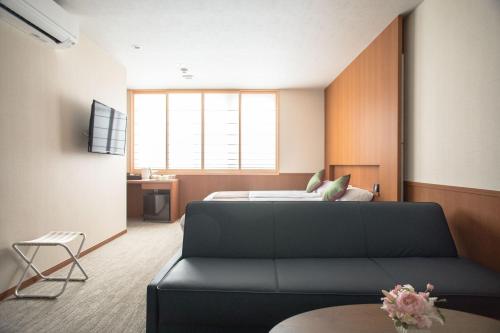 a living room with a couch and a bed at Number 6 Nijo in Kyoto