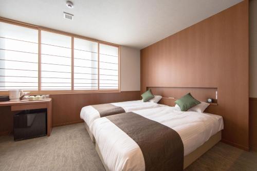 a bedroom with a large bed and a television at Number 6 Nijo in Kyoto