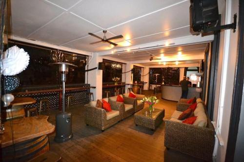 a living room with couches and a table at Grand Hotel Healesville in Healesville