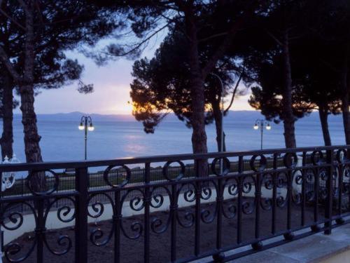 a black fence with a view of the ocean at Hotel Holiday Sul Lago in Bolsena