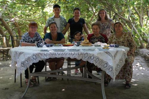 a group of people sitting at a table at Amir Hostel in Samarkand