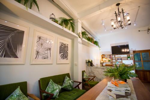 a dining room with a table and chairs and a chandelier at Victory Park Hostel in Bangkok