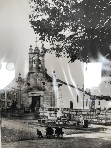 an old church with three animals standing in front of it at Agroturismo Casal de Castro in Mirandela