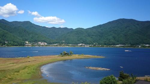 an island in the middle of a large body of water at Lakeland Hotel Mizunosato in Fujikawaguchiko