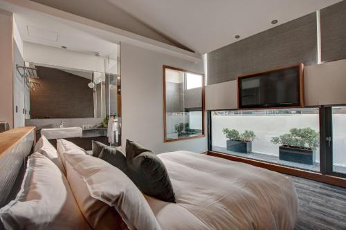 a living room with a large bed and a tv at EG Hostel in Nantou City