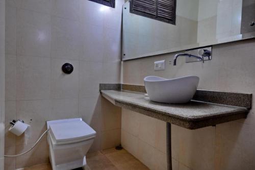 a bathroom with a sink and a toilet at Hotel Diamond Inn in Chandīgarh