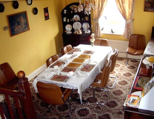a dining room with a table and chairs at Birtley House Guest House B&B in Telford