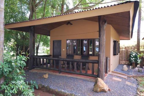 a small house with a wrap around porch at Melina Beach Front Bungalows in Tha Lane Bay