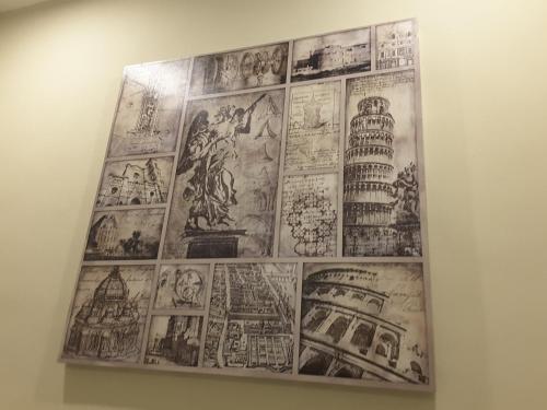 a wall with alot of drawings on the wall at Laman Kurnia Holiday House in Kota Bharu