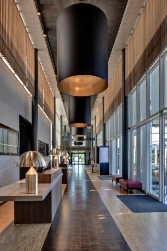 a lobby of a building with a large chandelier at Hotel Sempachersee in Nottwil