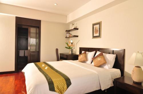 a bedroom with a large white bed with pillows at Eastpana Executive Residence 304 Prachinburi in Si Maha Phot