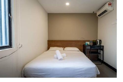 a bedroom with a bed with two towels on it at MAX Hotel Subang Jaya in Subang Jaya