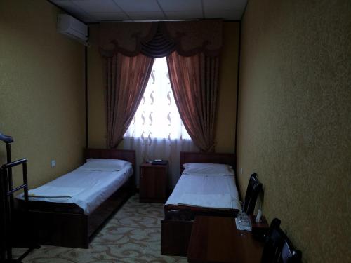Ліжко або ліжка в номері Dangara Hotel