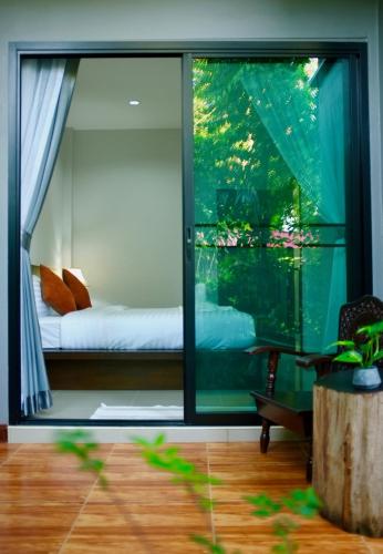a room with a view of a bed and a window at Smile Home Krabi Klong Moung Beach in Klong Muang Beach