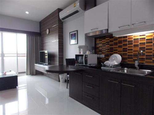 a kitchen with a sink and a counter top at Eastpana Executive Residence 304 Prachinburi in Si Maha Phot