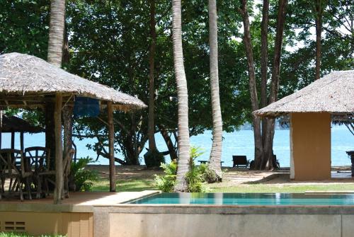 a resort with a swimming pool and a beach at Melina Beach Front Bungalows in Tha Lane Bay