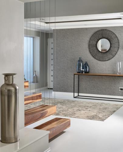 a kitchen with glass walls and a mirror at Grand Blue D in Cape Town