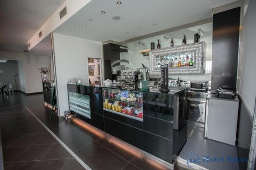 a restaurant with a counter with a drink bar at Hotel Relax Roma Nord in Fiano Romano
