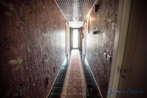 a long hallway with a red carpet on the wall at Hotel Relax Roma Nord in Fiano Romano