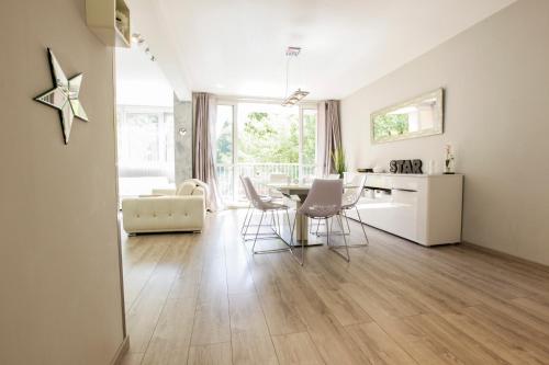 a kitchen and living room with a table and chairs at Le Célestay in Villeurbanne