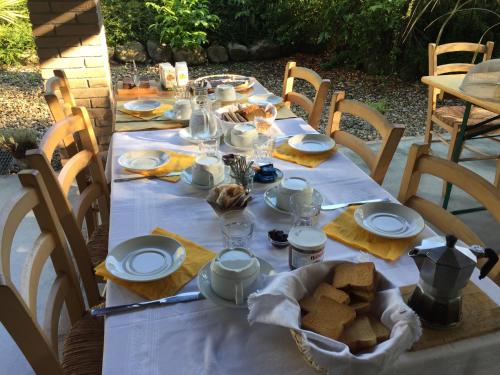 a table with a white table cloth and food on it at Agriturismo Spizzirò in Ponte Nizza
