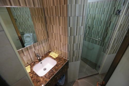 a bathroom with a sink and a shower at Pantai Regal Hotel in Kuantan