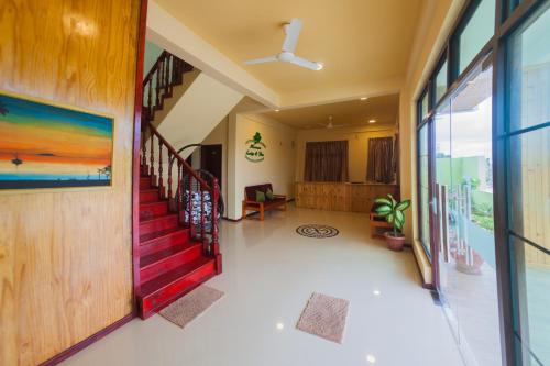 a hallway with a red staircase in a house at Annama Lodge and Dive in Hoarafushi