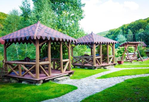 a group of wooden gazebos in a park at Tsisarske Urochyshe in Rozgirche