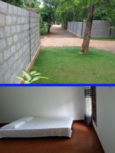 a room with a bed next to a wall at Afenta Motel- Mihintale in Mihintale