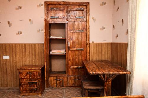 a room with a wooden cabinet and a table at Guest house Dilijan Orran in Dilijan