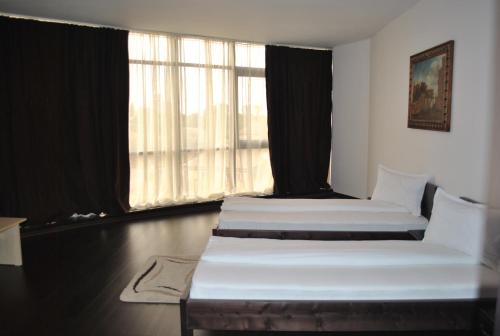 Llit o llits en una habitació de Hotel Taverna Pecicana