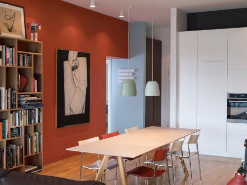 a dining room with a table and some bookshelves at Reykjavík Central Apartments in Reykjavík